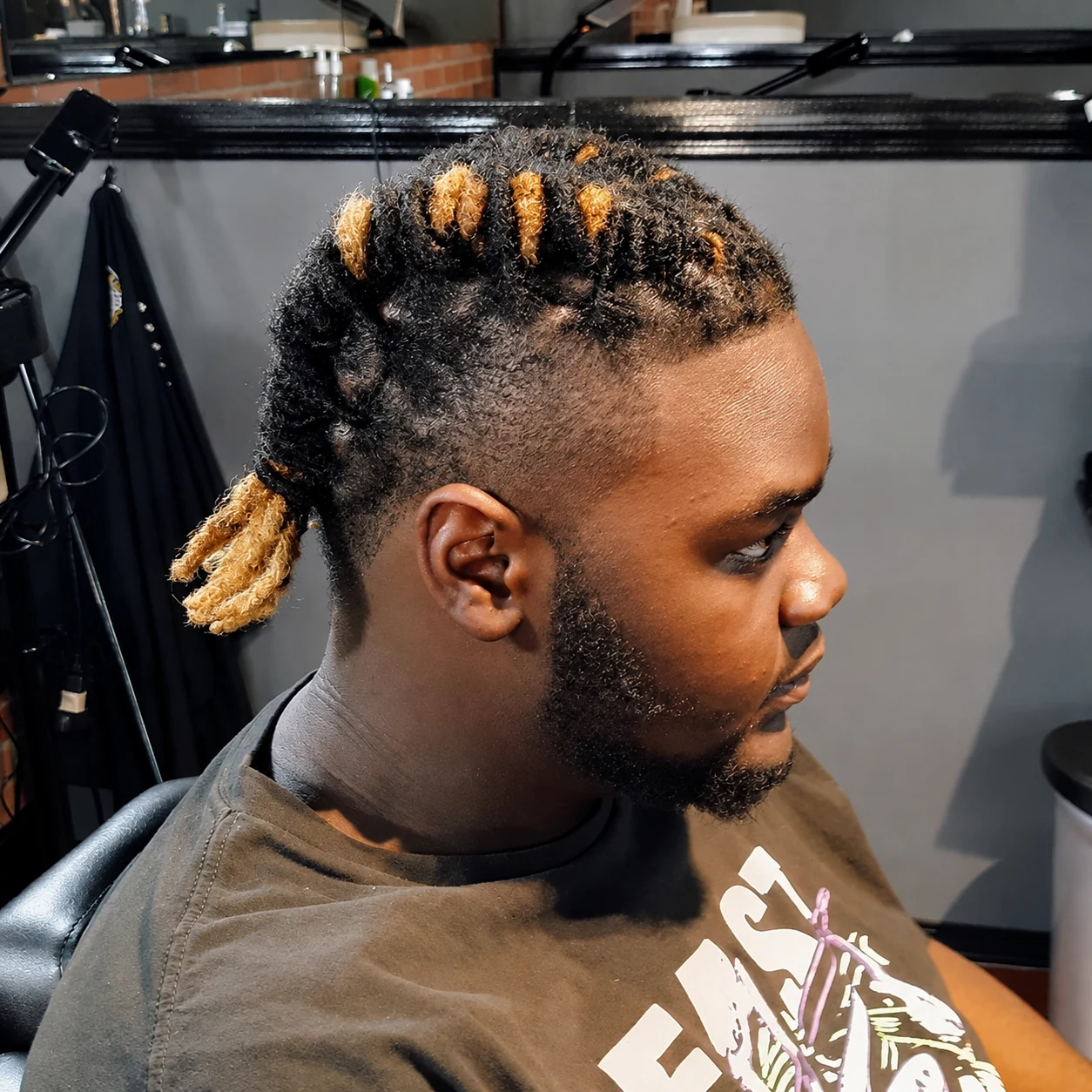 Tied locs with honey-colored tips, a taper and beard from Ayesha’s portfolio